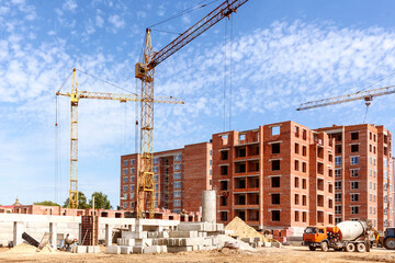 Panoramic view of the construction site with tower cranes. Construction of a new residential area of high-rise buildings.