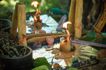 Love magic Nature Altar Candle burns with herbs, magic among candles, attract love, positive energy...