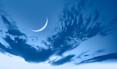 Obraz na płótnie Canvas Ramadan Kareem background -Crescent moon and sea at amazing sunset with lot of stars
