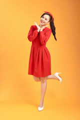 Happy smiling female wearing casual attire with excited facial expression, keeping palms under chin...