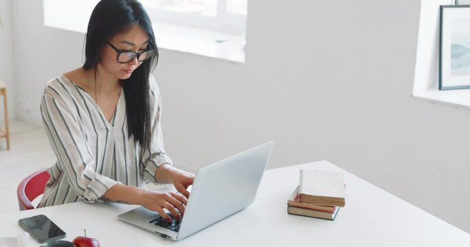 A woman freelancer works at home using a laptop. Businesswoman concept