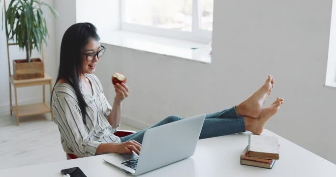 A woman freelancer works at home using a laptop. Businesswoman concept