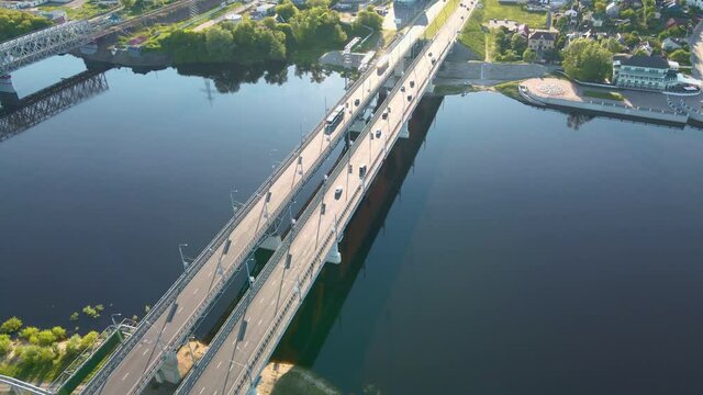 Cars traffic on bridge over the river in city, aerial view. Top view of bridge over Sozh river in Gomel, Belarus. Birds eye view cityscape