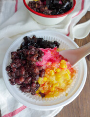 Homemade popular iced dessert of Malaysia / Ais Kacang / A concoction of finely shaved ice, red bean, corn, grass jelly, cendol, palm sugar syrup, evaporated milk, coconut milk and aromatic rose syrup