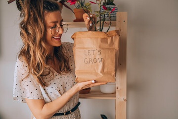 Woman taking care of plants at her home.