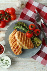 Concept of tasty eating with grilled chicken on white wooden table