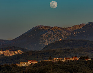 Full moon over the mountains in corfu