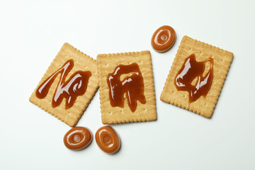 Cookies with caramel on white background, top view