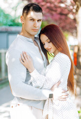 Luxury couple on spring blossom background. Lovers having romantic moments