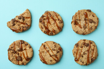 Cookies with caramel on blue background, top view