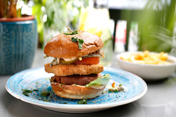 Vegetarian burger with tofu cheese and vegetables. A colorful appetizing dish. Culinary photography, food styling.