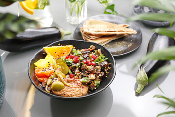 Humus with eggplant and olive salad. Vegetarian cooking.
A colorful appetizing dish. Culinary photography, food styling.