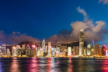 Hong Kong downtown skyline across Victoria harbor at night, Hong Kong, China.