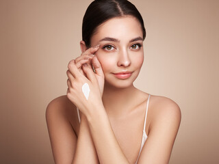 Beauty woman applying cream on her hands. Young woman with clean fresh skin