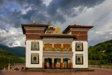 Scenic view of Rangjung Woesel Choeling buddhist temple and monastery under a sky with dark clouds,...