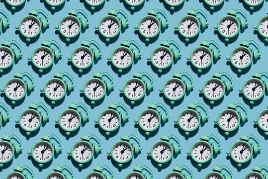 Table clock pattern in modern style with hard shadows, flat lay. Budtbook on a blue background in the form of a pattern. Irregular pattern.
