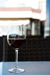 a glass of red wine in a glass at the bar