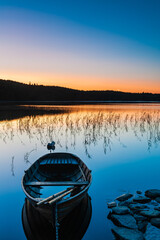 Row boat at lake during sunrise