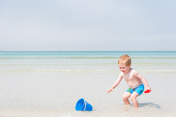 Child boy playing on beach