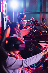 Fototapeta na wymiar teenagers in vr headsets playing racing game in car simulators
