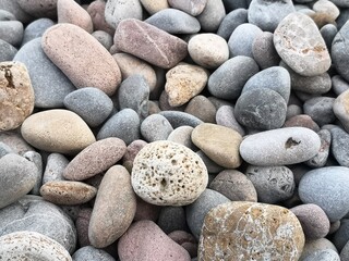 Fototapeta na wymiar Beach pebbles wallpaper by the mediterranean coast