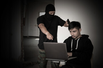 Terrorist using gun threaten hacker for damage in security network.