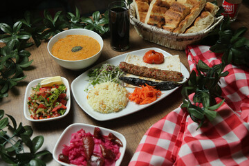 Turkish Adana Kebab with fresh vegetables on flatbread Top view, flat lay