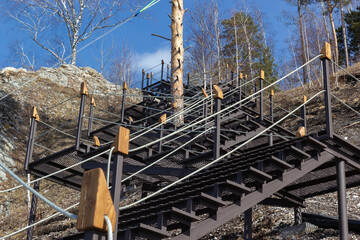 A well-equipped trail with an iron staircase to the mountain. Tourism concept.