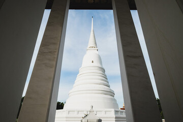 A large white pagoda against the blue sky in the background.