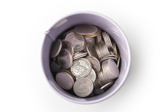 Top view of pile of Thai coins in a can bank isolated on a white background, saving money.