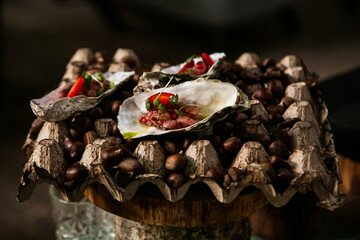 original serving of sea oysters, with strawberries on chestnuts