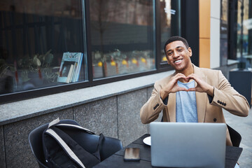 Joyful male person working in favorite company