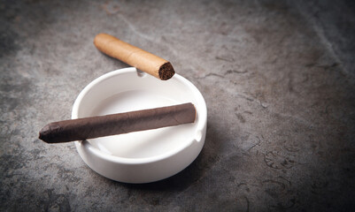  Cigar and ashtray on table. Smoking