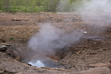 Fototapeta na wymiar Geyser in Iceland is still bubbling after an eruption in a volcanic landscape in Iceland
