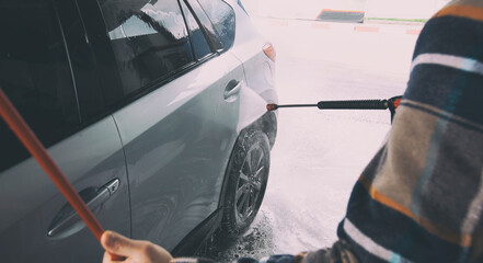 The man washing his car on self-service car wash