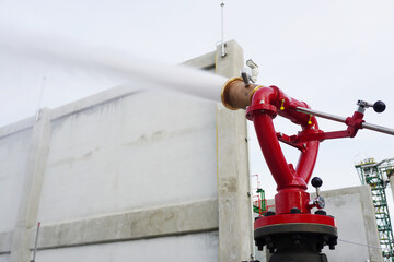 Water flowing vigorously from open fire hydrant as part of the fire extinguishing system testing...