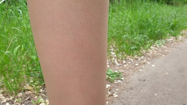 a mosquito bites a woman's leg, an insect stings a man