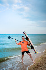 Men on beach with surfboard. surfer man holding serf board. Summer vacation concept. Summer sport