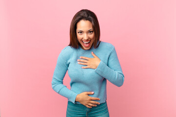 young hispanic woman laughing out loud at some hilarious joke