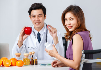 Asian doctor and patient advertising vitamins