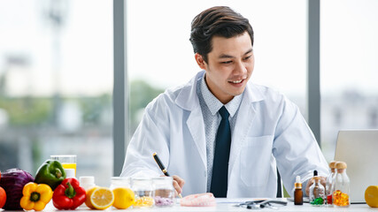 Happy Asian doctor making notes