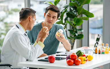 Doctor discussing vitamins with Asian patient