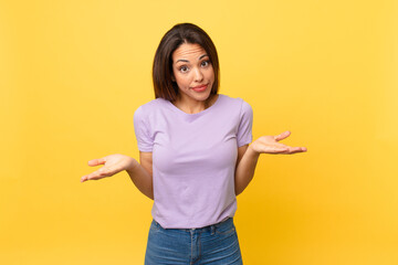 young hispanic woman feeling puzzled and confused and doubting