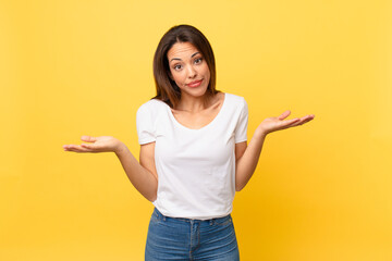 young hispanic woman feeling puzzled and confused and doubting