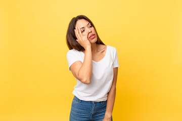 young hispanic woman feeling bored, frustrated and sleepy after a tiresome