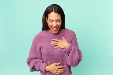 young hispanic woman laughing out loud at some hilarious joke