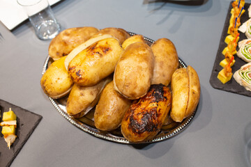 Baked potatoes with bacon on table, top view