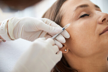 Dark-haired Caucasian woman undergoing a mesotherapy procedure