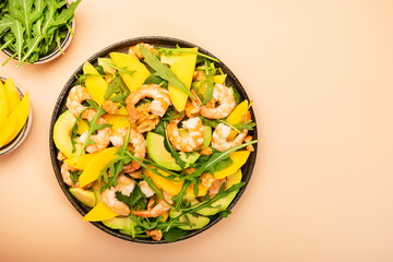 Seafood Salad with Mango, Shrimps and Avocado, Walnut, Spinach and Arugula. Top view, pink background