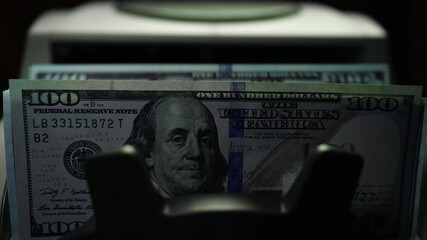 Bill Counting Machine Counting On Hundred Dollar Bills. Money Counting Equipment Financial Operations. Currency Exchange of One Hundred Usd. Counting USA Cash - Powered by Adobe